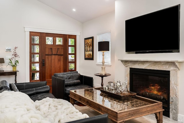 living room featuring vaulted ceiling and a premium fireplace