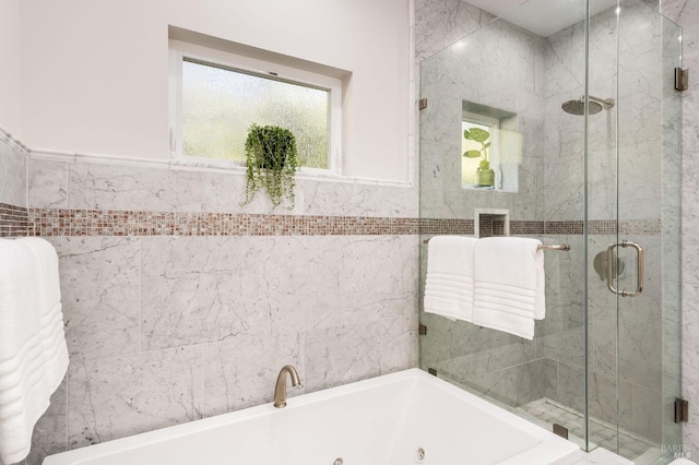 bathroom featuring shower with separate bathtub, tile walls, and a wealth of natural light