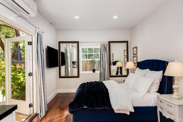 bedroom featuring dark hardwood / wood-style floors and a wall mounted air conditioner