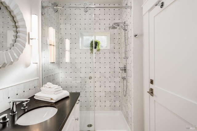 bathroom with an enclosed shower and vanity