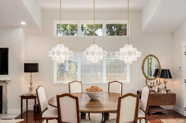 dining space featuring hardwood / wood-style floors, a chandelier, and a wealth of natural light