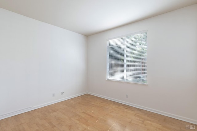 spare room with light hardwood / wood-style floors