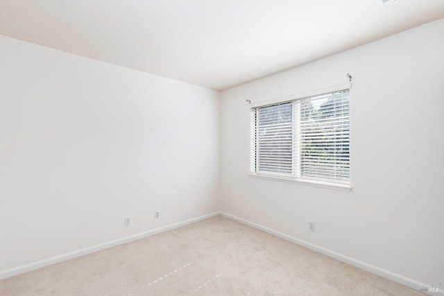 spare room with light colored carpet