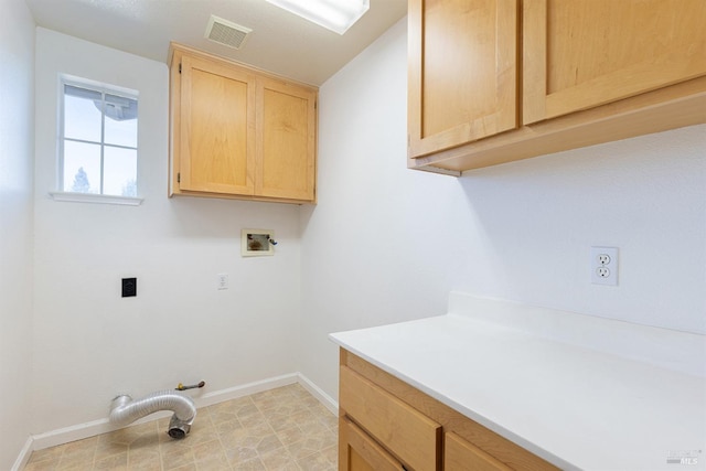 clothes washing area featuring washer hookup and cabinets