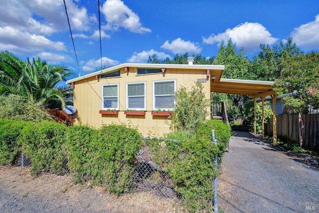 view of side of property featuring a carport