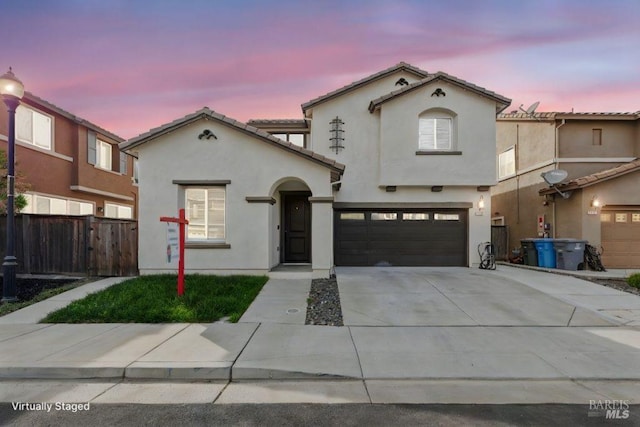 mediterranean / spanish-style home with a garage