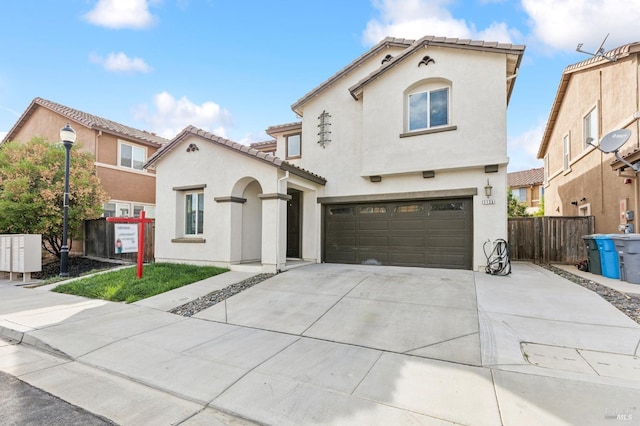 mediterranean / spanish house featuring a garage