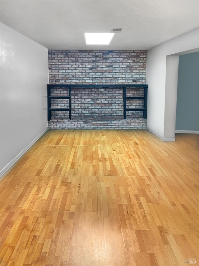 basement with light hardwood / wood-style floors