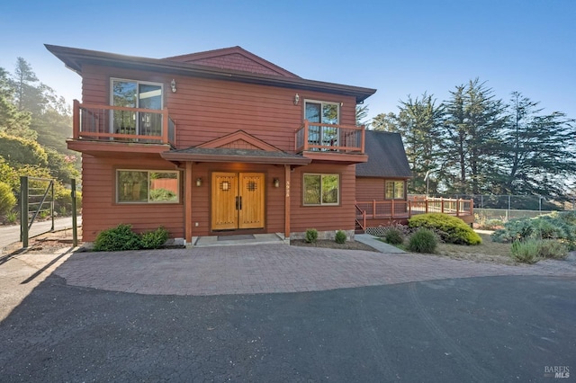 view of front of house featuring a balcony