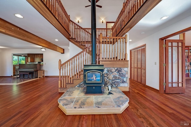 living room featuring a wood stove and wood-type flooring