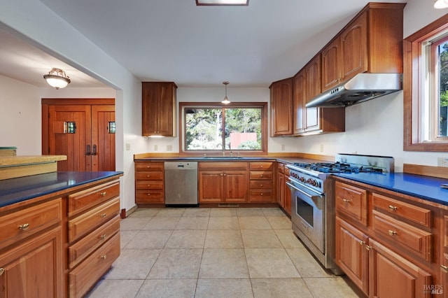 3925 Bay Hill Rd, Bodega Bay, CA 94923 - kitchen featuring brown cabinetry, under cabinet range hood, a wealth of natural light, and appliances with stainless steel finishes