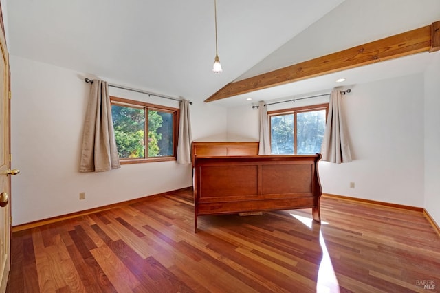 unfurnished bedroom featuring high vaulted ceiling, hardwood / wood-style floors, and multiple windows