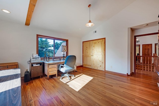 home office with beamed ceiling, light hardwood / wood-style floors, and high vaulted ceiling