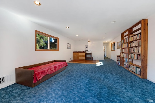 sitting room featuring dark carpet