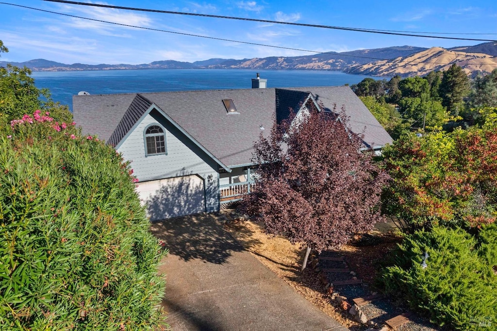 birds eye view of property featuring a water and mountain view