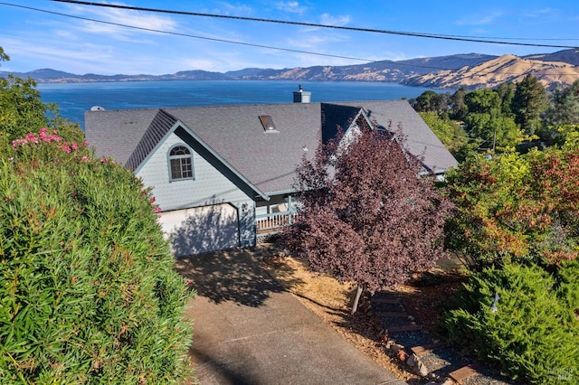 birds eye view of property featuring a water and mountain view