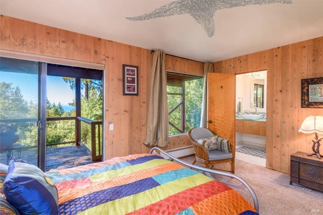 38120 Ocean Ridge Dr, Gualala, CA 95445 - carpeted bedroom with wood walls, a baseboard heating unit, access to outside, and ensuite bathroom