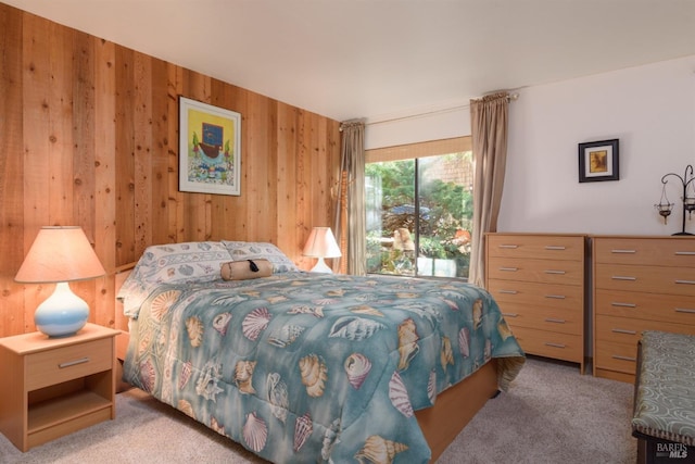 carpeted bedroom with wood walls