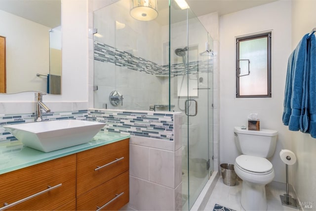 bathroom with toilet, vanity, an enclosed shower, and tile walls