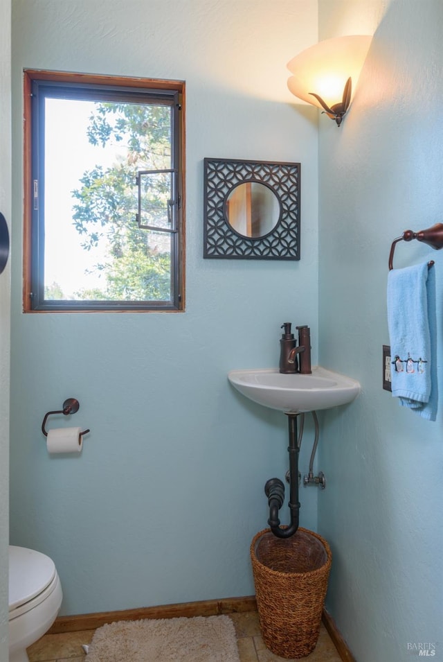 bathroom featuring tile patterned flooring, sink, and toilet