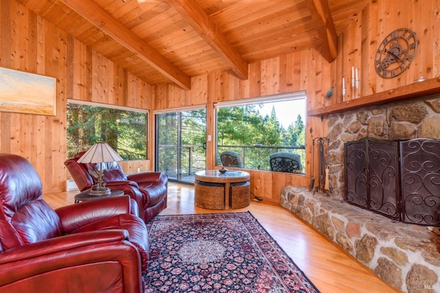 living room with wooden walls, hardwood / wood-style flooring, wooden ceiling, and beam ceiling