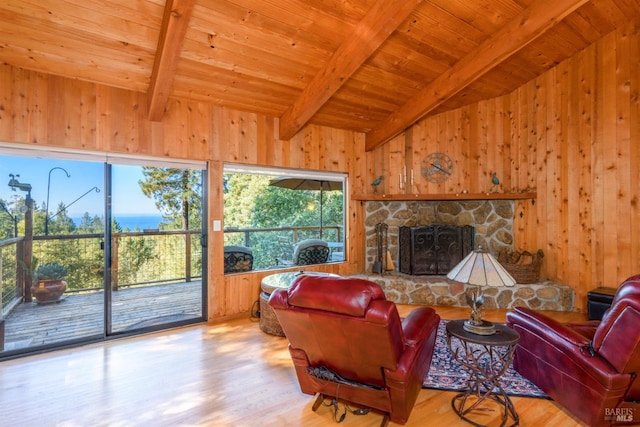 living room featuring a fireplace, wood ceiling, light hardwood / wood-style flooring, wooden walls, and lofted ceiling with beams