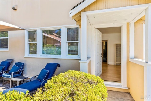 view of exterior entry featuring stucco siding