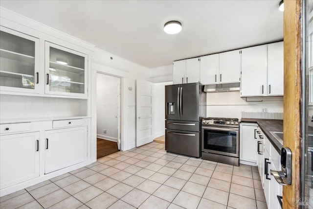 kitchen featuring refrigerator with ice dispenser, under cabinet range hood, white cabinetry, glass insert cabinets, and stainless steel gas range