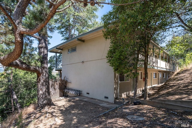 view of side of home featuring a balcony