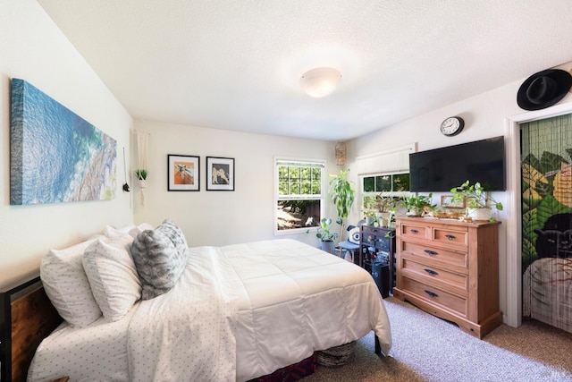 carpeted bedroom featuring a textured ceiling