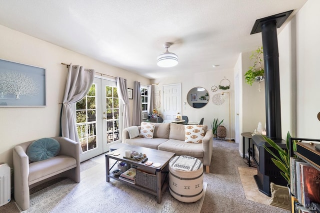 living room with light carpet, french doors, and a textured ceiling