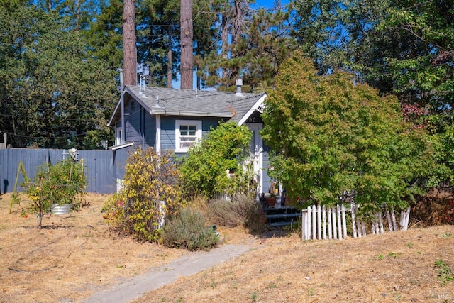 view of side of home featuring fence