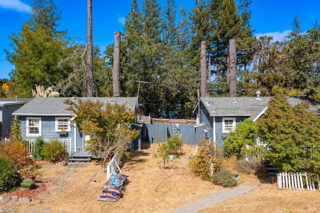 view of front of home with fence and a deck