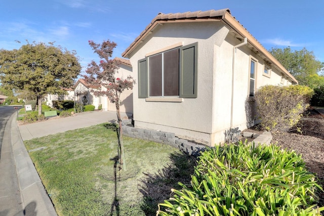 view of side of property with a yard