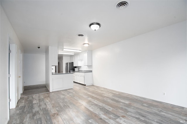 unfurnished living room with light hardwood / wood-style floors