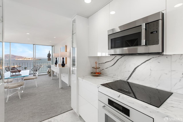 kitchen with decorative backsplash and white cabinets