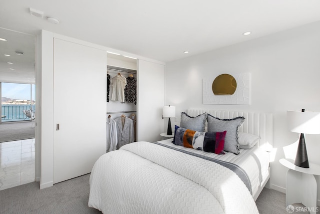 bedroom featuring a closet and light colored carpet