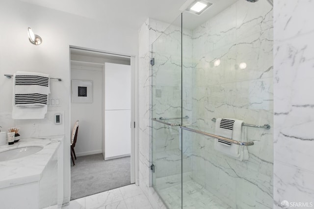 bathroom featuring vanity and a shower with shower door