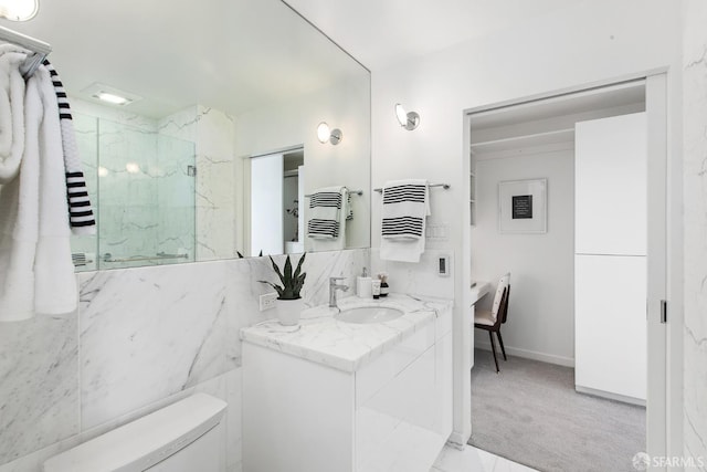 bathroom featuring toilet, vanity, and a shower with door