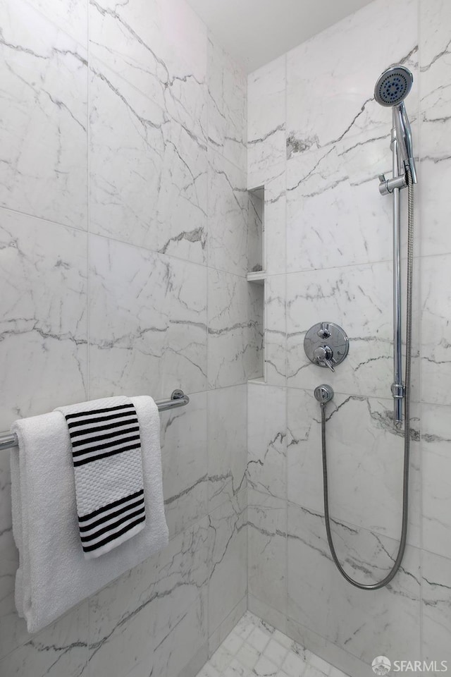 bathroom with tiled shower