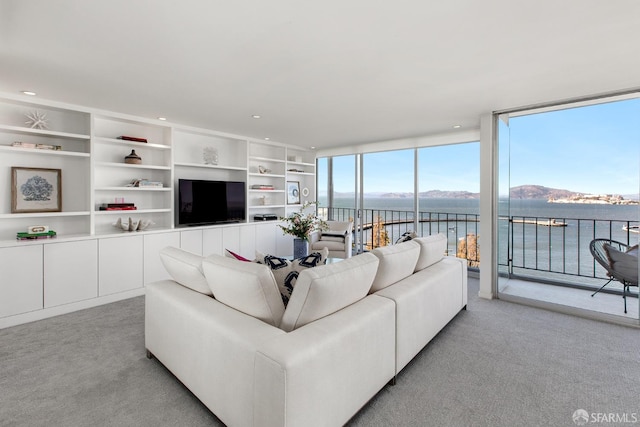 carpeted living room featuring floor to ceiling windows