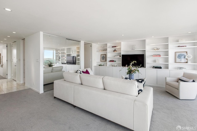 living room with light carpet and built in shelves