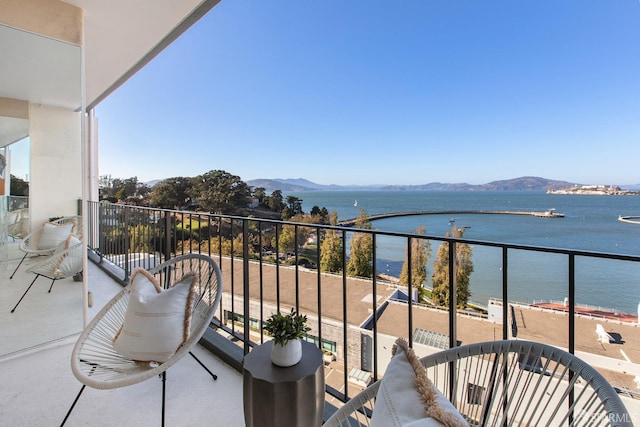 balcony with a water and mountain view