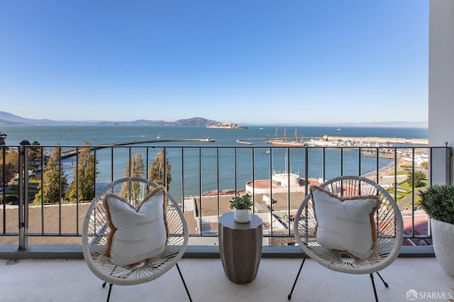 balcony with a water and mountain view