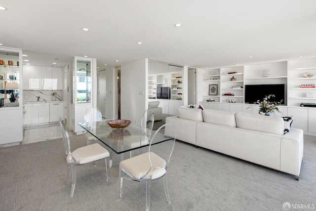 living room with light carpet and built in shelves