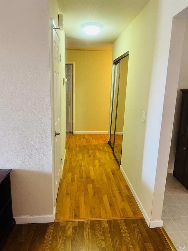 hallway with light hardwood / wood-style flooring