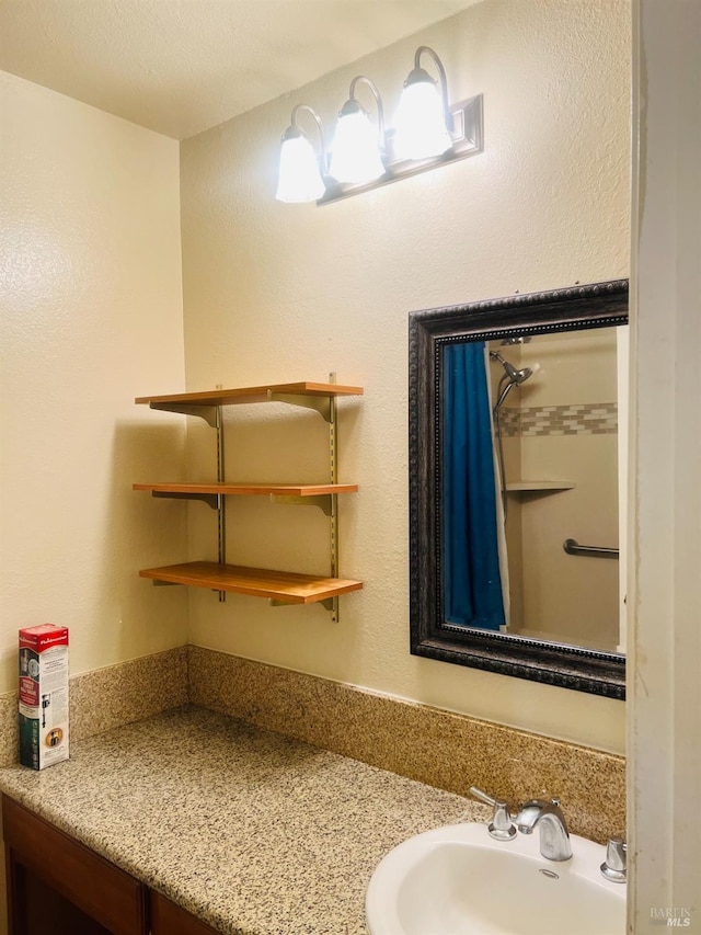 bathroom featuring sink and a textured ceiling