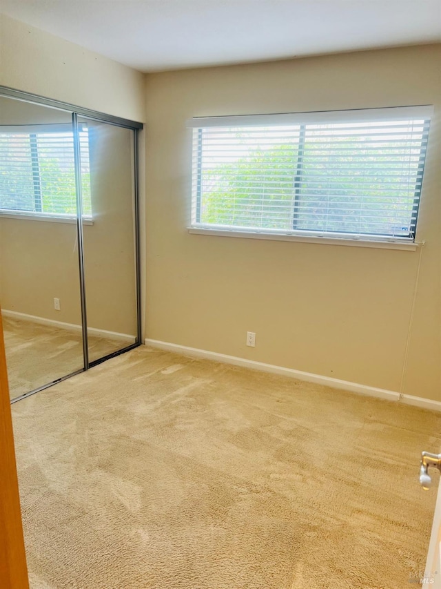 unfurnished bedroom with carpet floors and a closet