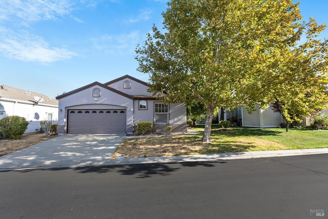 view of front of property with a front yard and a garage