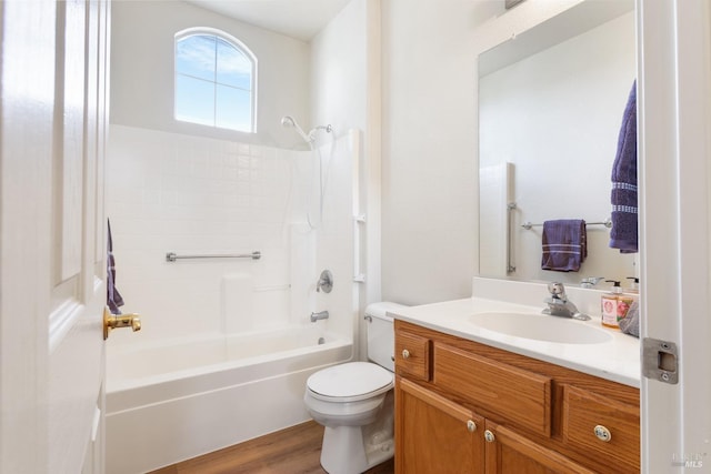 full bath with washtub / shower combination, wood finished floors, vanity, and toilet